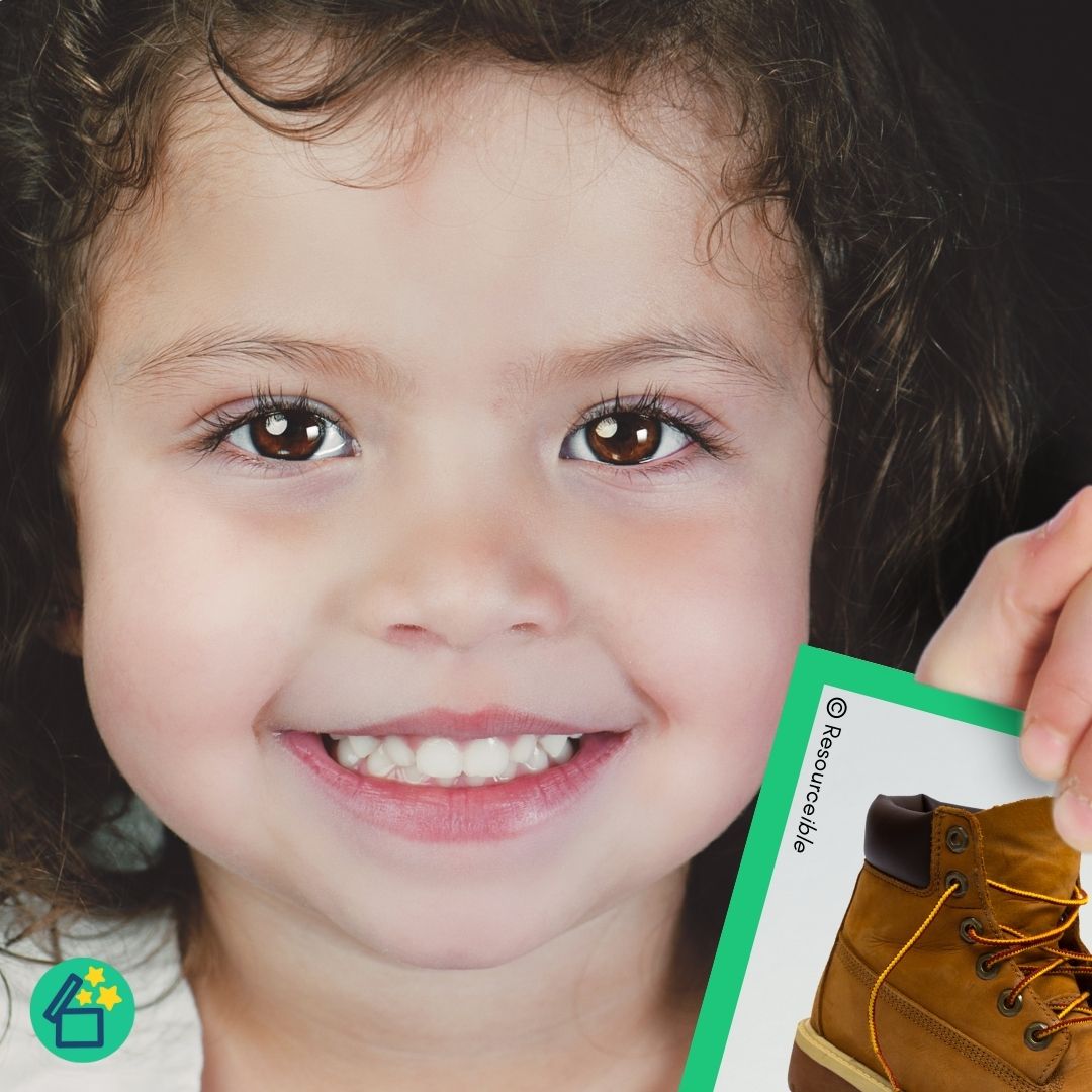 Little girl holding B flashcard by Resourceible.