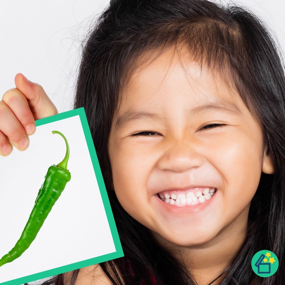 Happy little girl holding a CH sound flashcards by Resourceible.